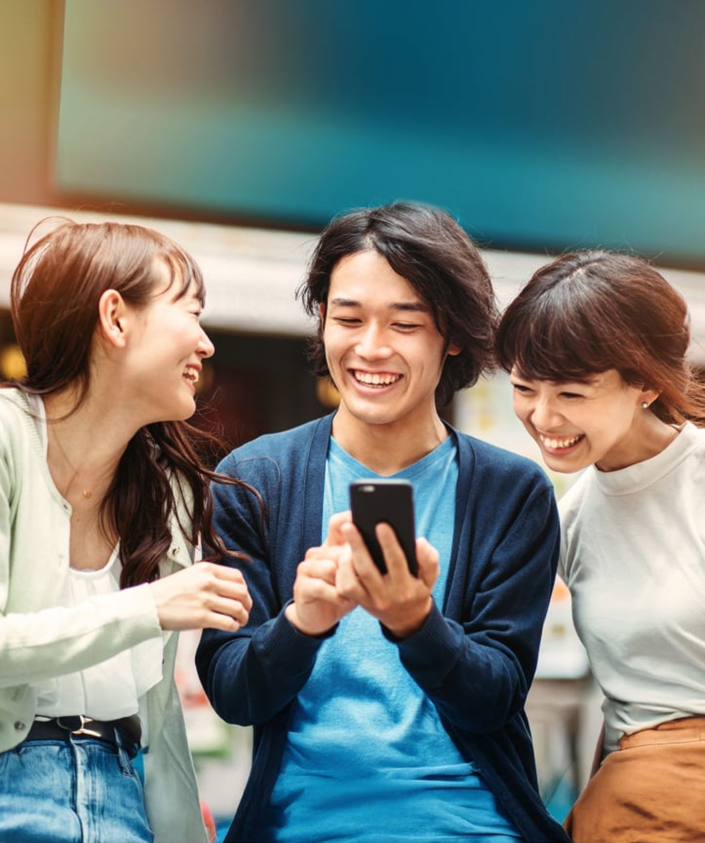 Group of 3 friends looking at their phones