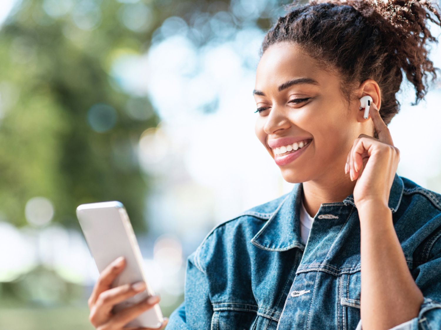 A woman using her phone to listen to music