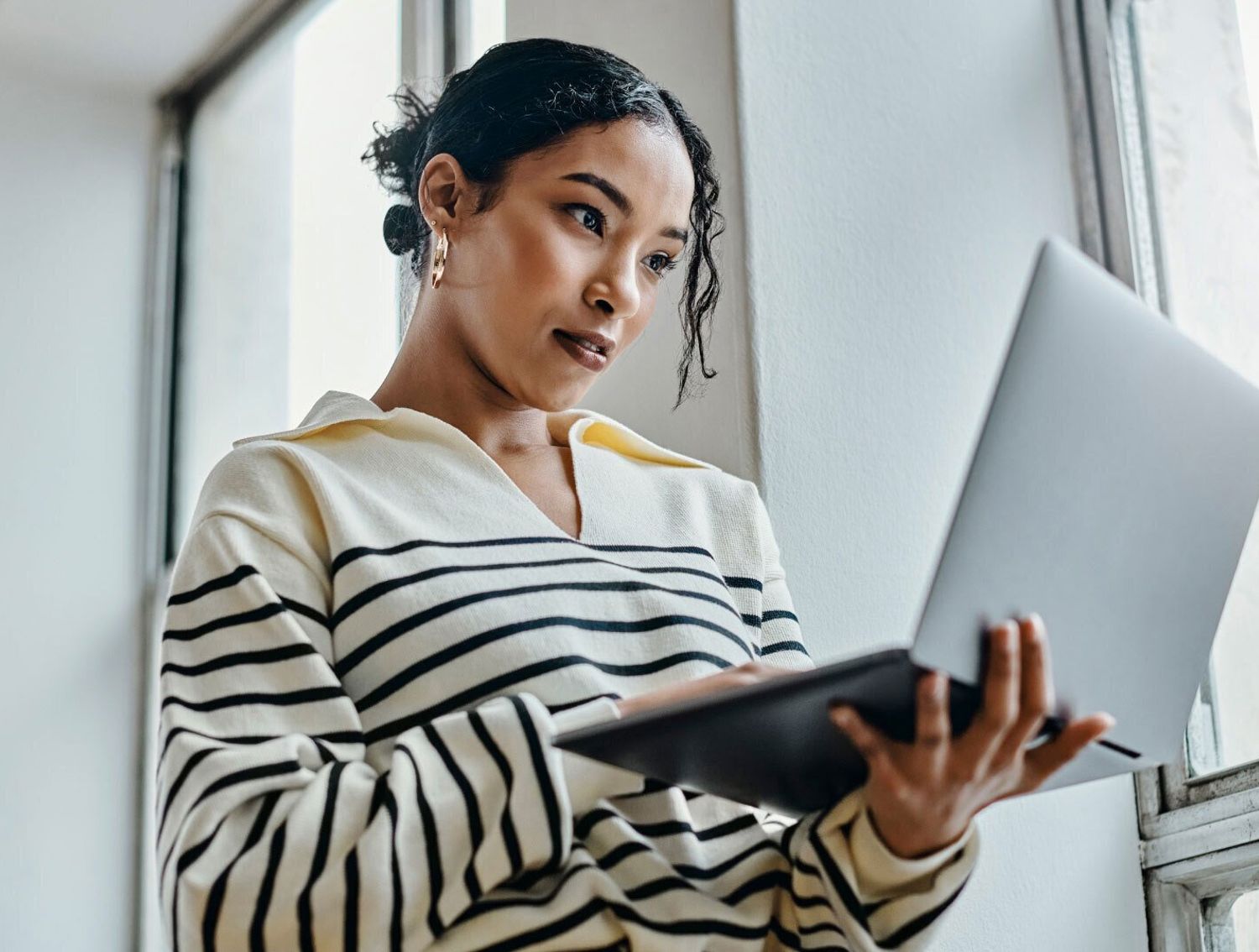 Woman holding her laptop