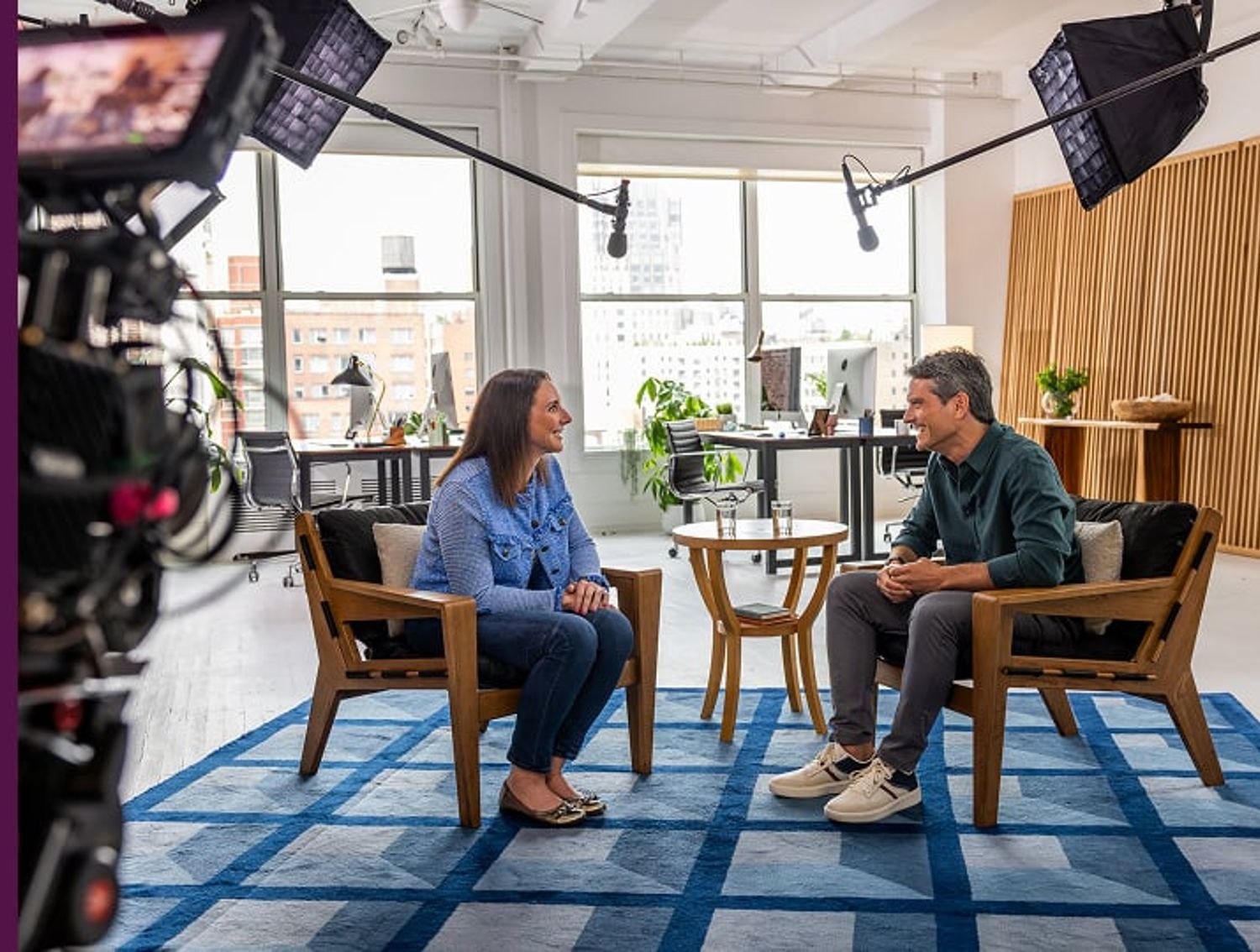 Two people being filmed during an interview