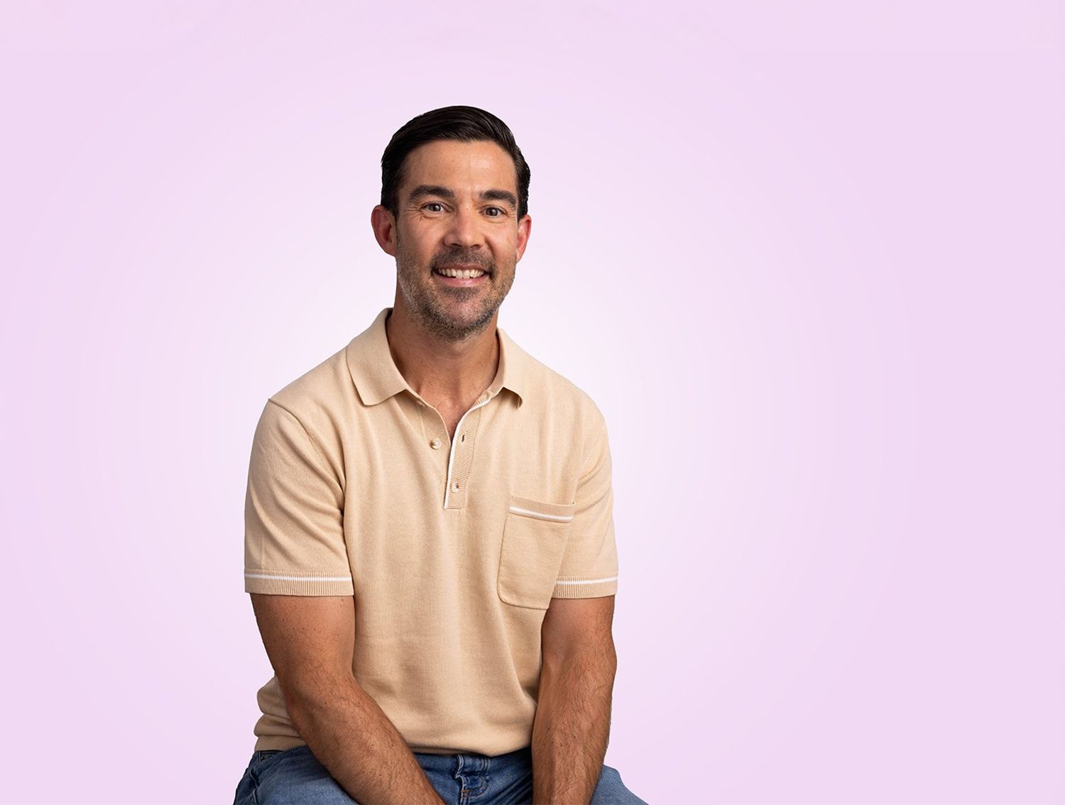 Man in front of a purple background