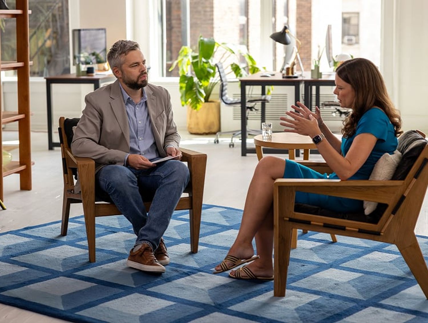 Two people conducting an interview while seated
