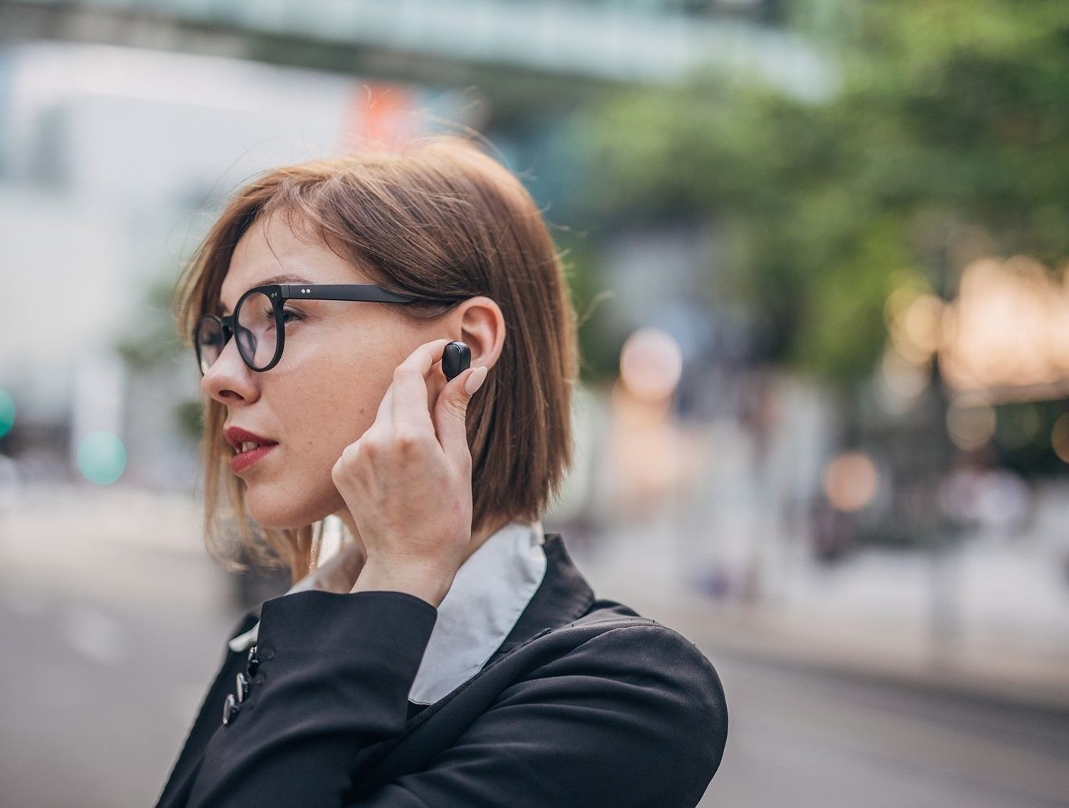 Woman listening to a bluetooth device in her ear