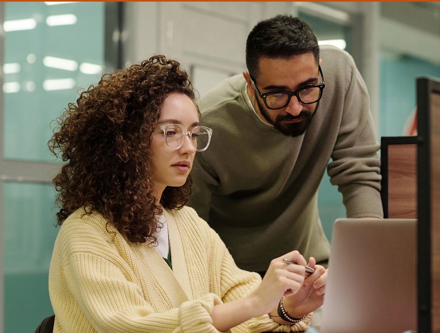 Two coworkers collaborating at a desk