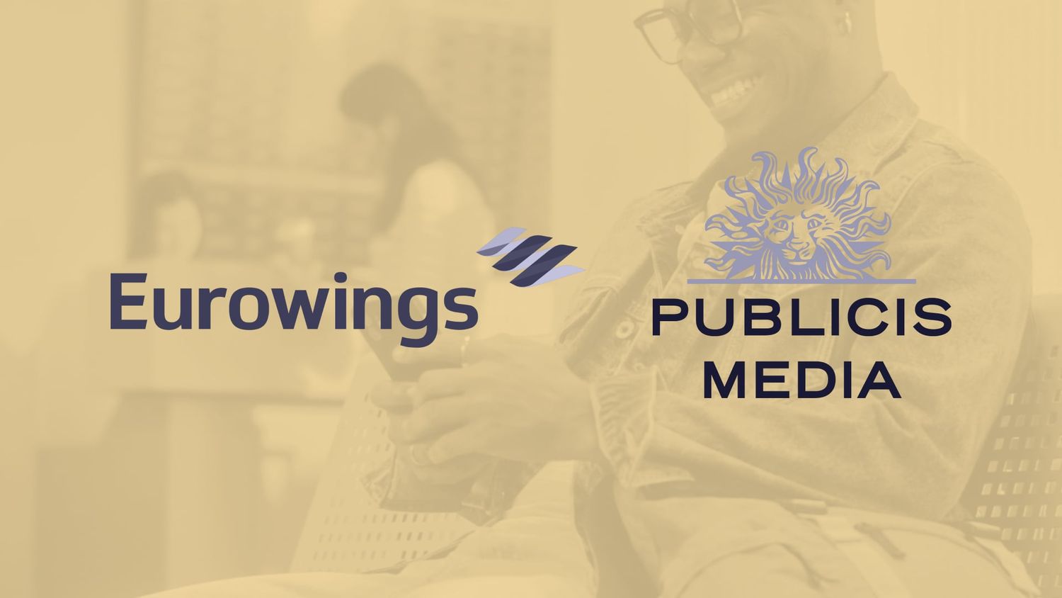 Eurowings and Publicis Media logos displayed over a tinted background of a man using his phone in a modern indoor setting.