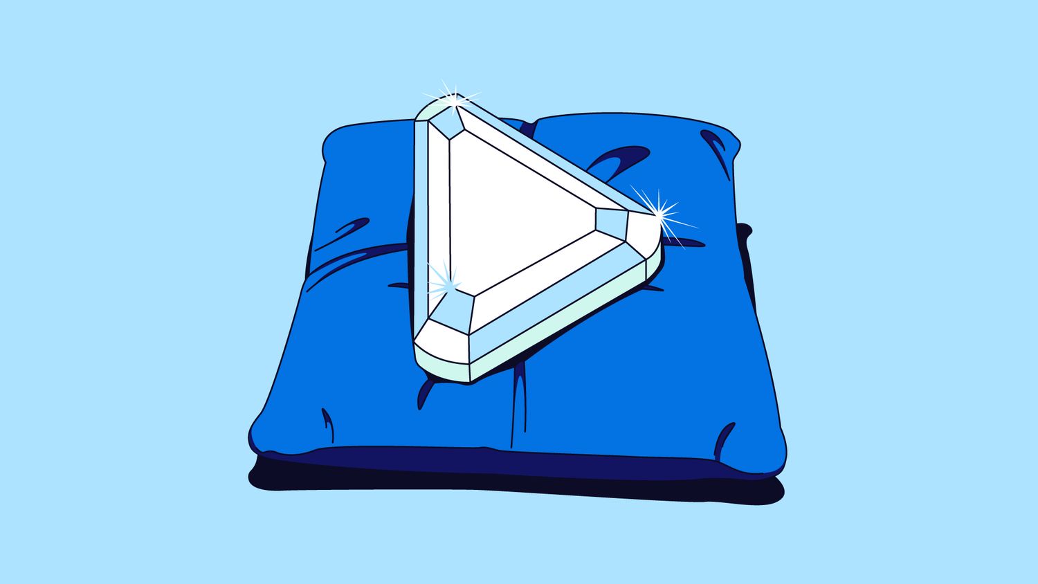 Play button-shaped diamond resting on a large cushion.