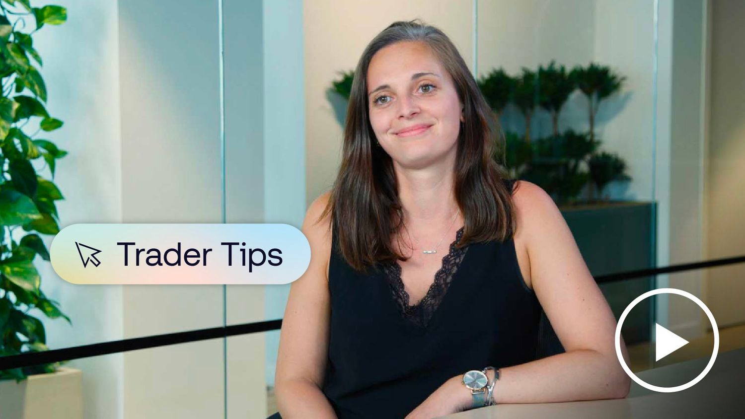 Photo of industry trader sitting at desk and smiling at camera.