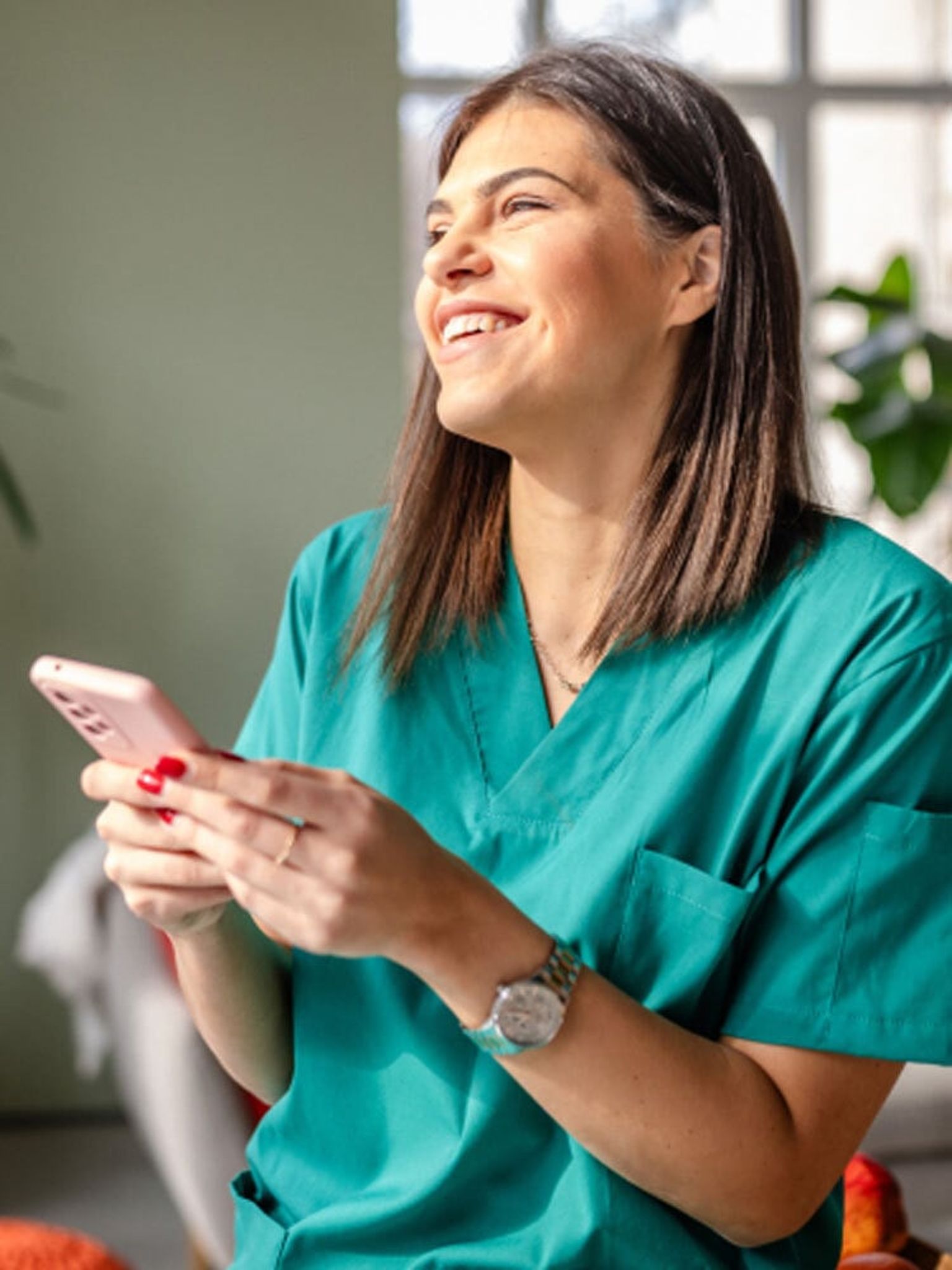 Woman smiling and holding her phone