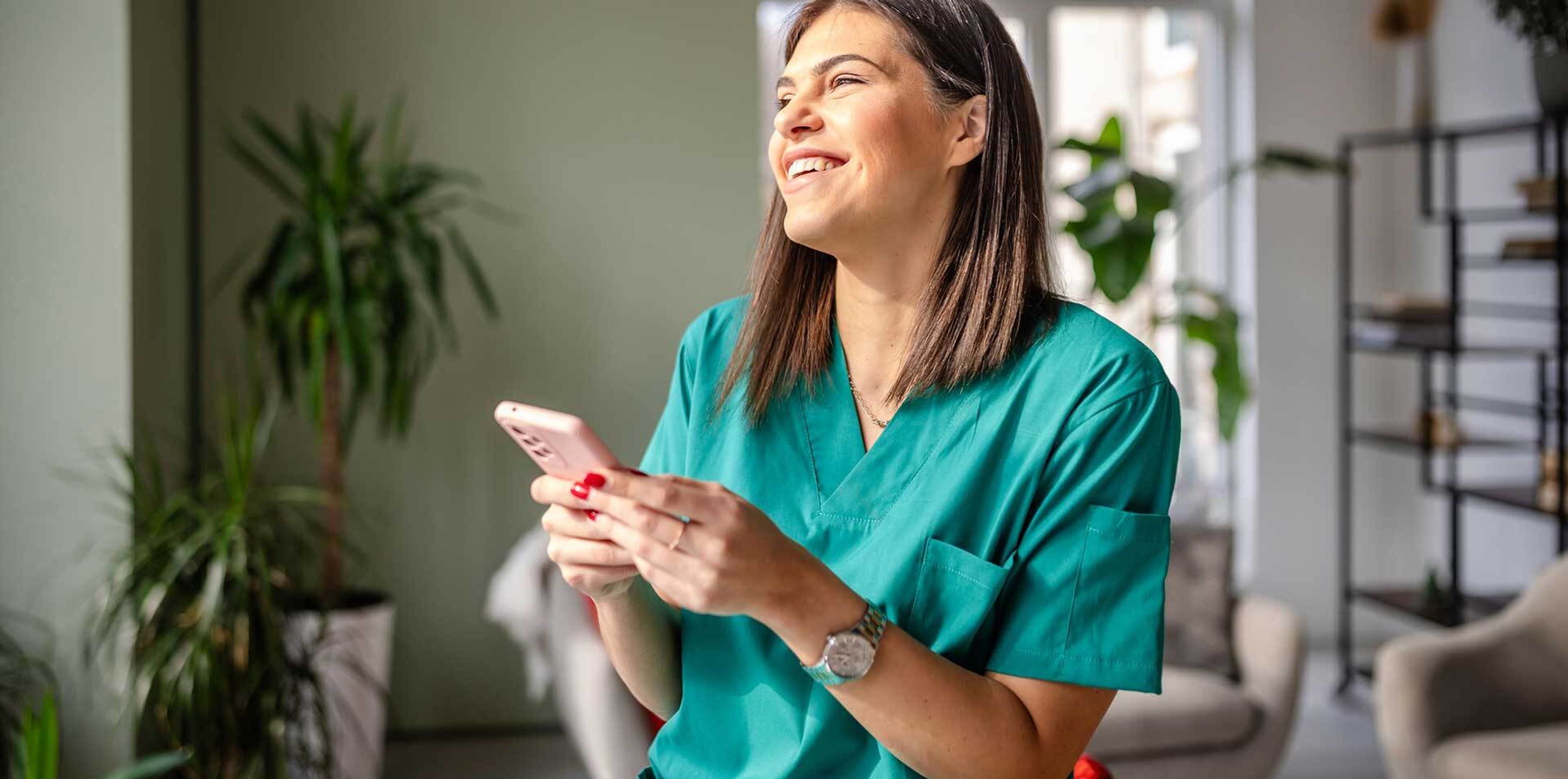 Woman smiling and holding her phone