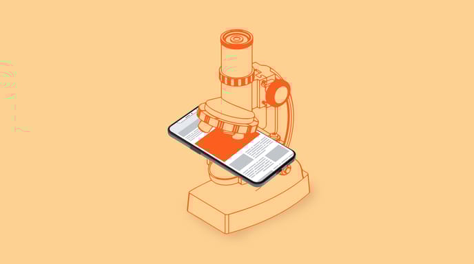 A phone sits under a microscope