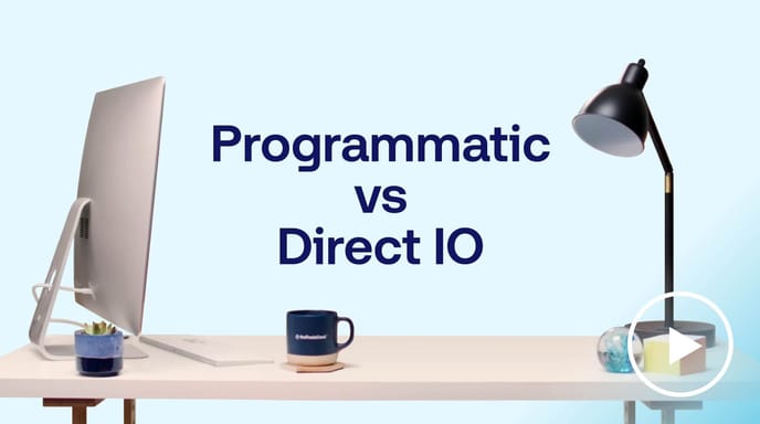 Desk with computer and lamp beside ‘Programmatic vs Direct IO’ text by The Trade Desk, comparing digital ad buying methods.