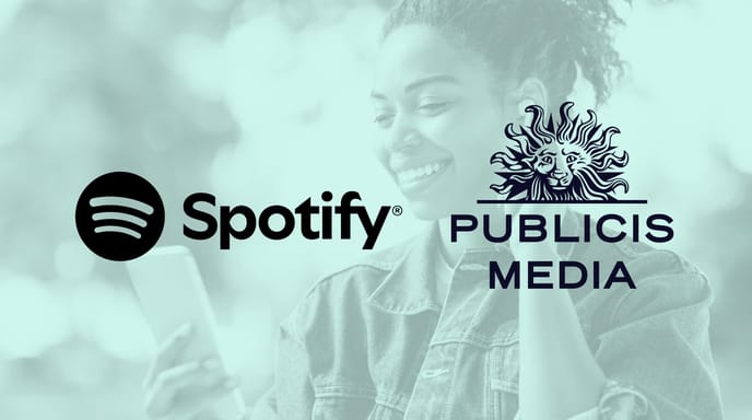 Spotify and Publicis Media logos displayed over a tinted background of a woman using a phone to listen to music with headphones on.