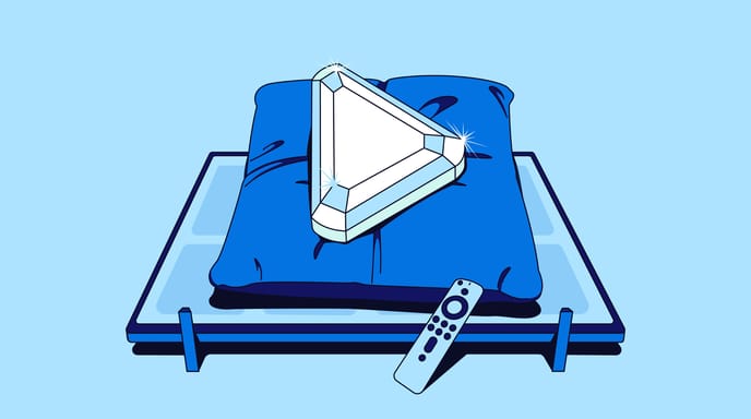 Illustration of a gemstone-shaped triangular play button resting on a blue pillow atop a platform, with a remote control in the foreground.