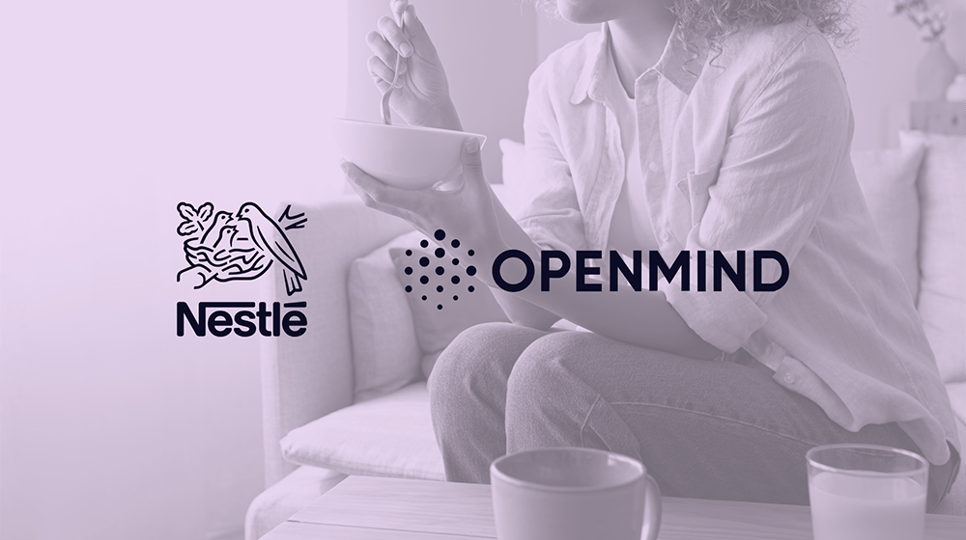 Woman sitting down and eating a bowl of Cheerios with a purple wash over and Nestle and Openmind logos in the center