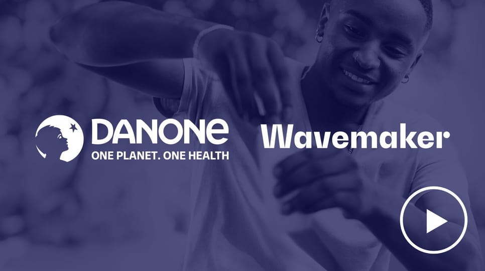 Success stories featuring Danone, Wavemaker, and The Trade Desk logos on a dark blue background with a smiling person in the background.