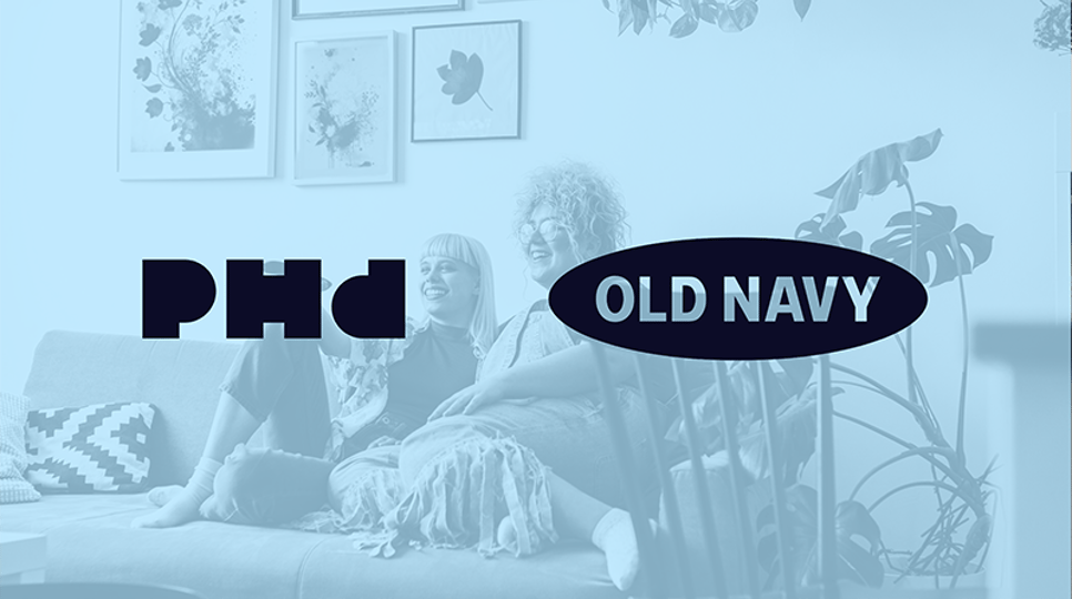 Photo pictures a couple on a couch watching TV and laughing with a blue filter and PHD and Old Navy logos over