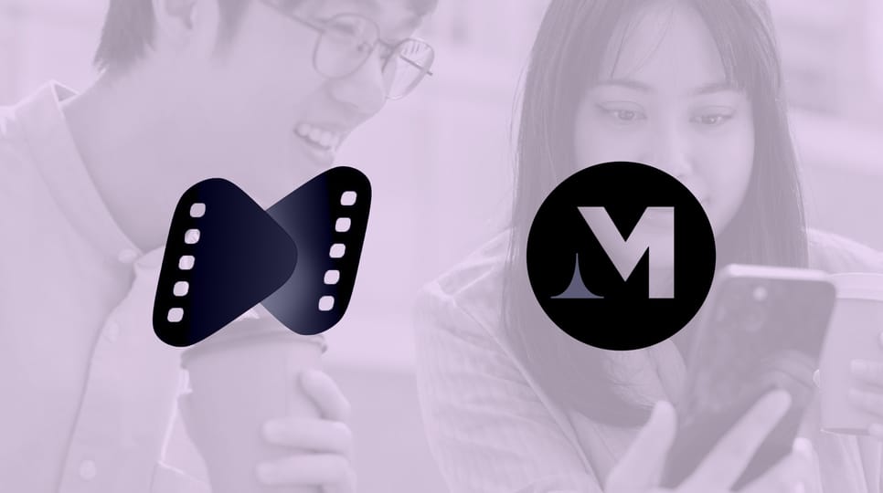 Two people holding coffee cups look at a smartphone together outdoors, with a translucent purple overlay with Madhouse and Netshort logos overtop.