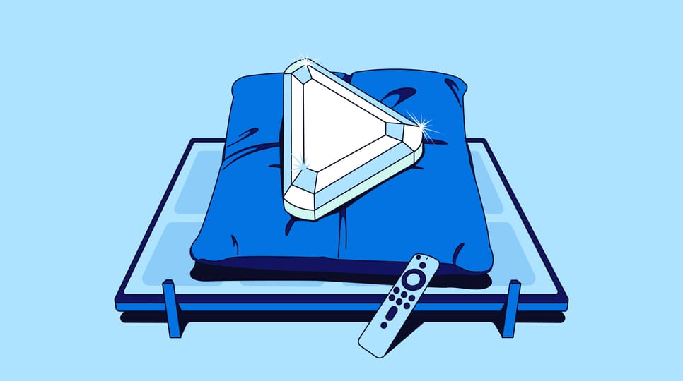 Illustration of a gemstone-shaped triangular play button resting on a blue pillow atop a platform, with a remote control in the foreground.