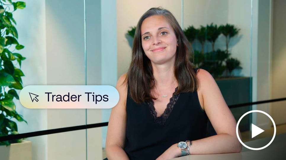Photo of industry trader sitting at desk and smiling at camera.