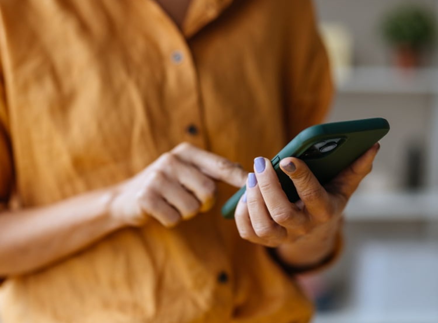 Image of a person's hands as they hold their phone