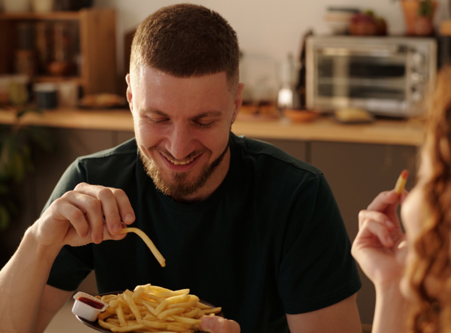 Image shows a person eating McDonald's fries