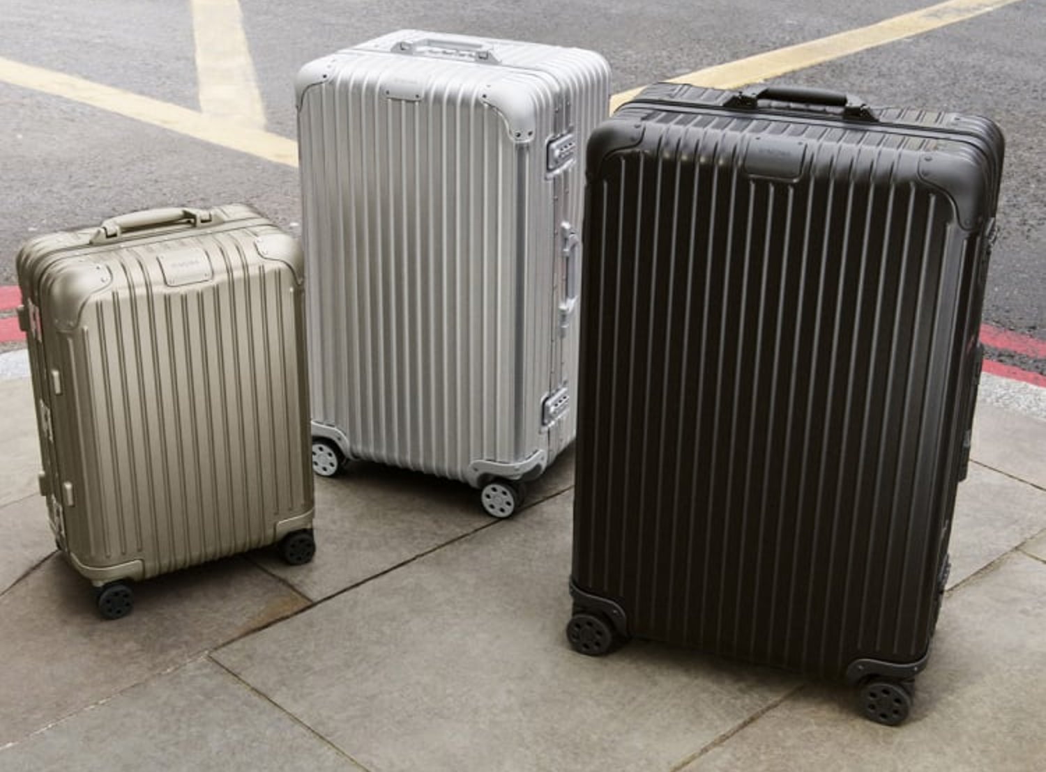 Image shows three different sized RIMOWA suitcases