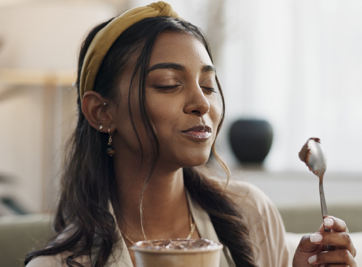 Picture of a woman eating ice cream with a spoon