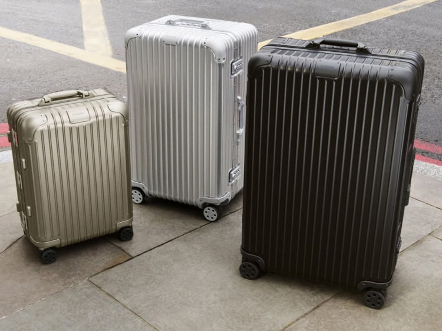 Image shows three different sized RIMOWA suitcases