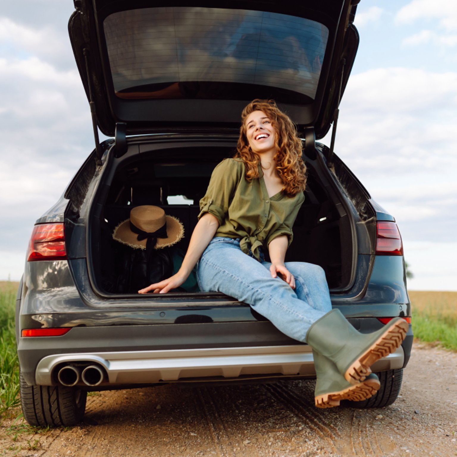 Woman sitting in Rear Hatch of SUV