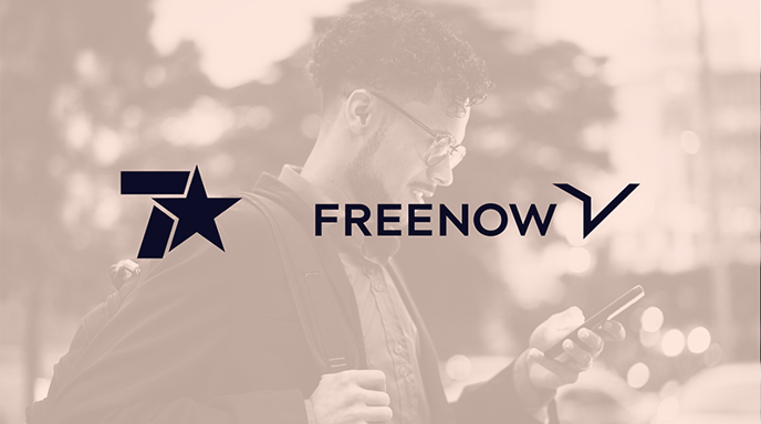 A promotional image with a warm-toned filter, featuring the FREE NOW logo and another star-themed logo over a background of a young man with glasses and a backpack smiling while looking at his phone outdoors.