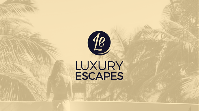 Image shows a woman standing on a balcony overlooking palm trees and basking in the sun with a yellow filter over and the Luxury Escapes logo in the middle