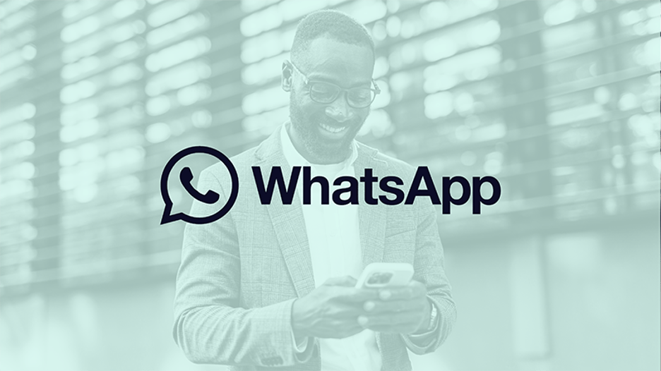 Image of a man smiling at his phone with a green filter over and the WhatsApp logo in the center