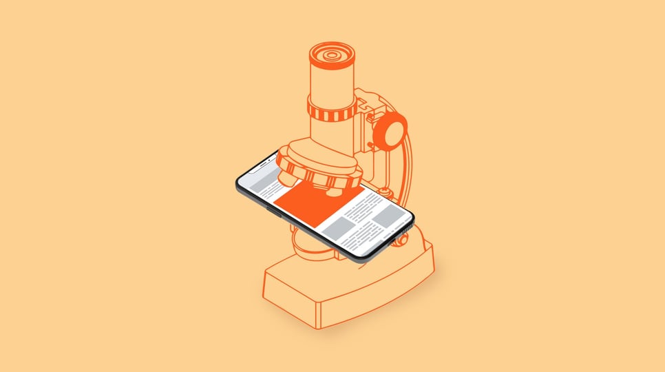 A phone sits under a microscope