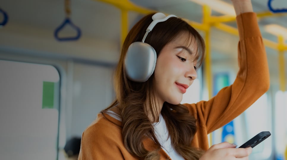 Woman riding the train and looking at her mobile phone.
